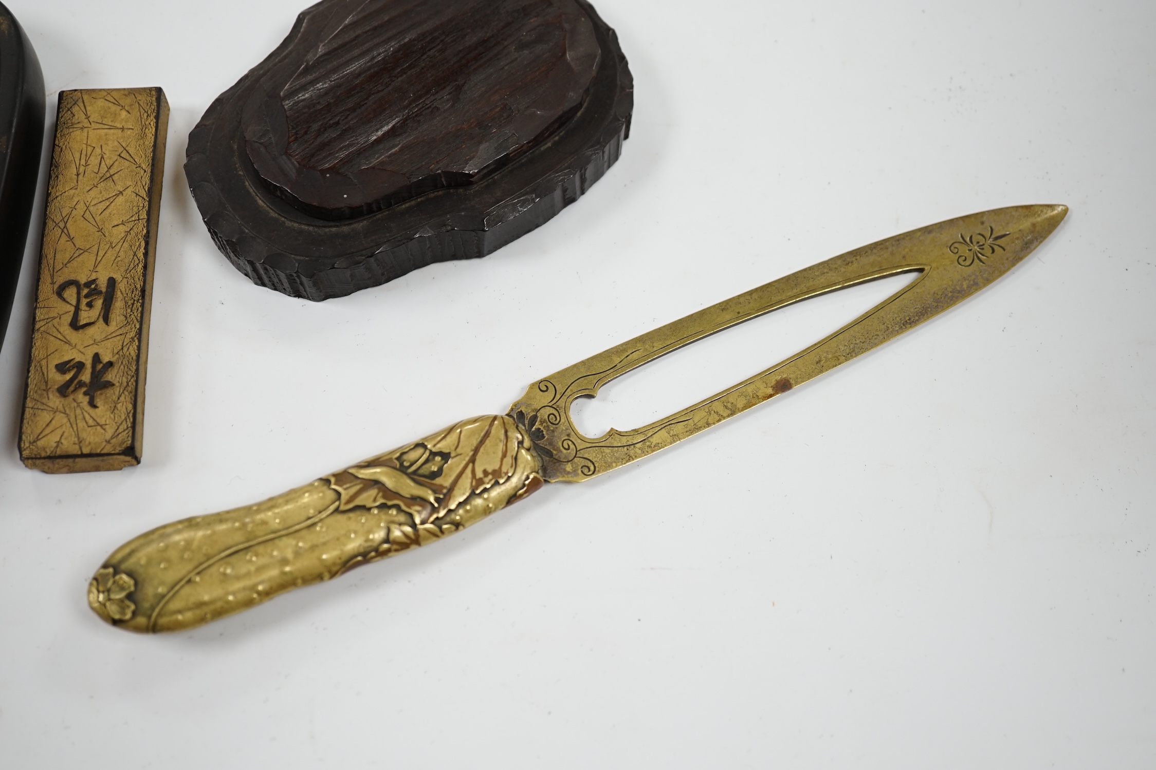 Literati interest: a Chinese red lacquer writing box, 26.5 x 24 x 6.5cm, with two inkstones, a brass paper cutter and ink cake. Condition - fair, some damage to edges and corners of the box